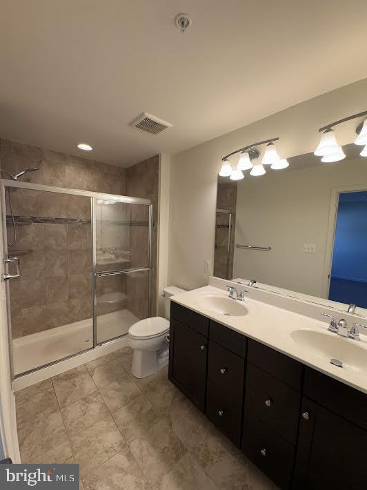 7806 Taggart Court Elkridge, MD 21075 - Photo 19 of 21 a bathroom with a double vanity sink toilet and shower