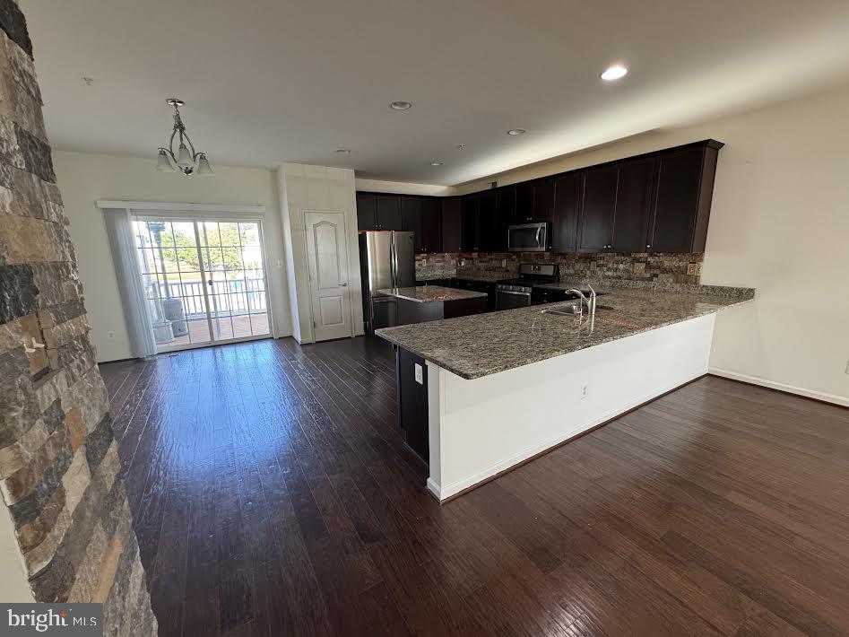 7806 Taggart Court Elkridge, MD 21075 - Photo 2 of 21 a kitchen with stainless steel appliances granite countertop a sink a stove and a wooden floors