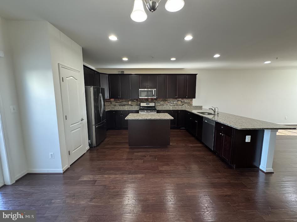 7806 Taggart Court Elkridge, MD 21075 - Photo 4 of 21 a kitchen with stainless steel appliances granite countertop a refrigerator a sink dishwasher and a microwave with wooden floor