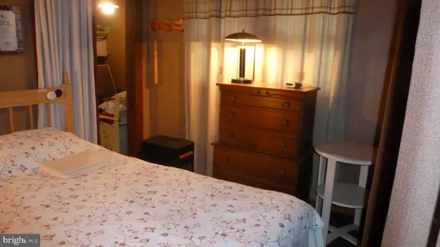 a bedroom with a bed and a mirror