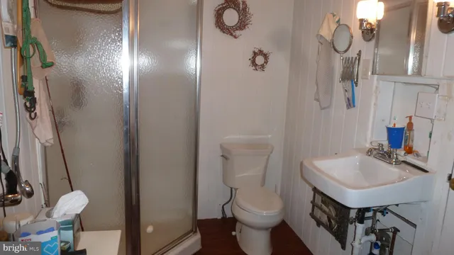 a bathroom with a sink toilet and shower