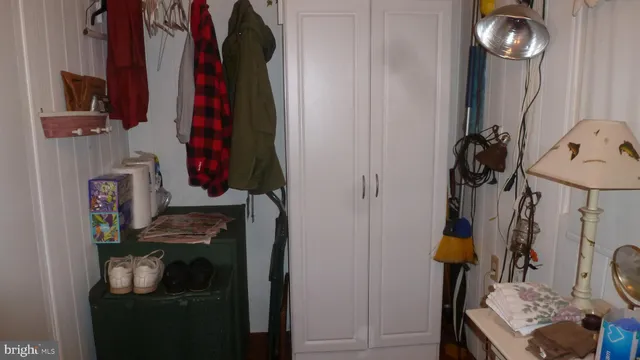 a room with a walk in closet and a mirror