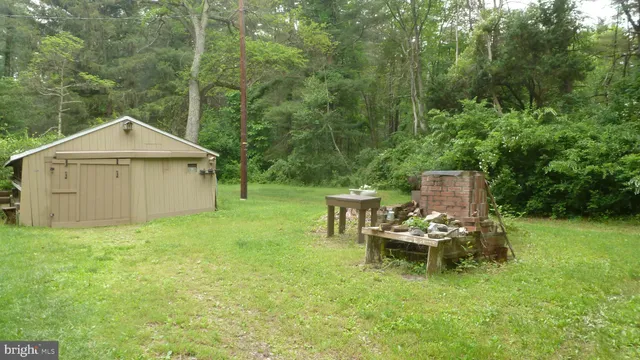 a view of a chair and table in the garden