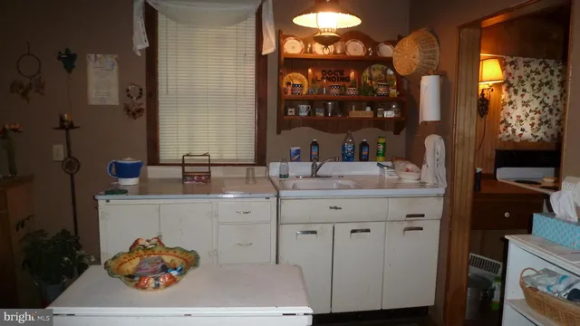 a bathroom with a sink vanity and a mirror