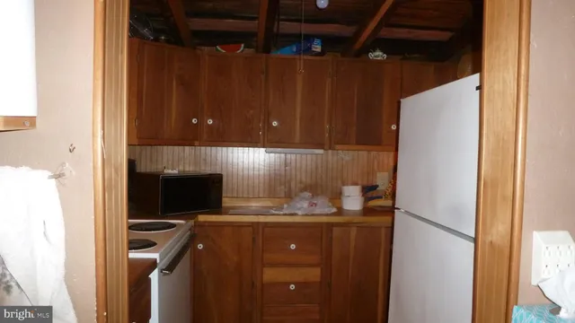 a kitchen with a refrigerator and cabinets