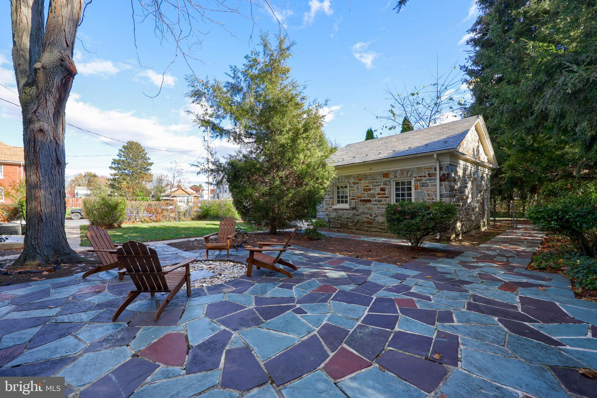 568 Chestnut Street Columbia, PA 17512 - Photo 59 of 68 a view of a patio with a dining table and chairs with a fire pit and a large tree