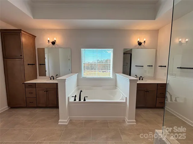 a bathroom with a shower and mirror