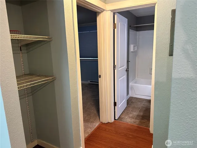a view of hallway with wooden floor