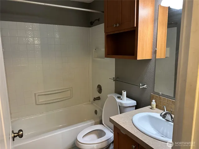 a bathroom with a sink a toilet and bathtub