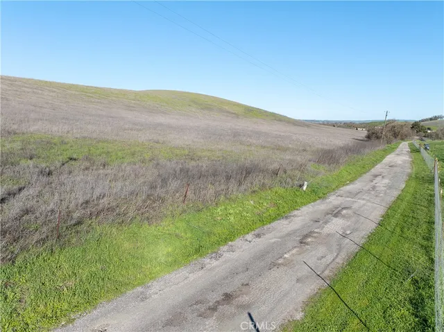 a view of a field with an ocean in the background
