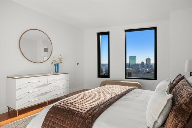 a bedroom with a bed and a dresser