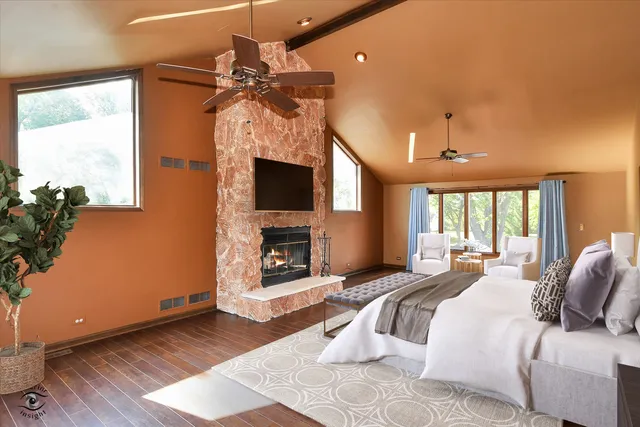 a view of a livingroom with wooden floor and a fireplace