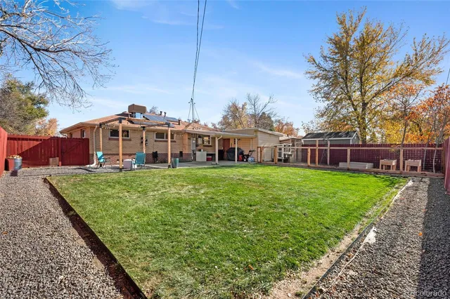 a view of a house with a yard table and chairs
