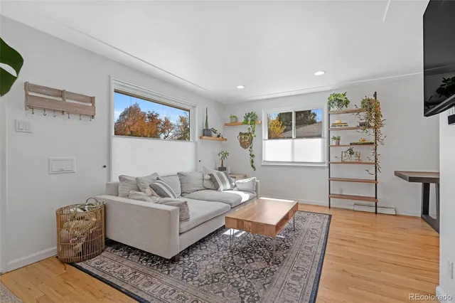 a living room with furniture and wooden floor