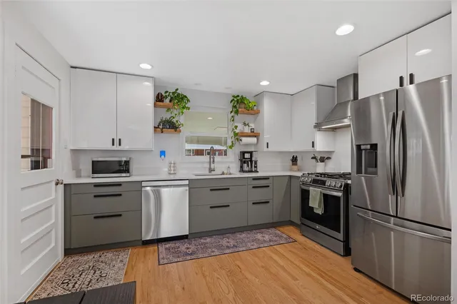 a kitchen with a sink stainless steel appliances and cabinets