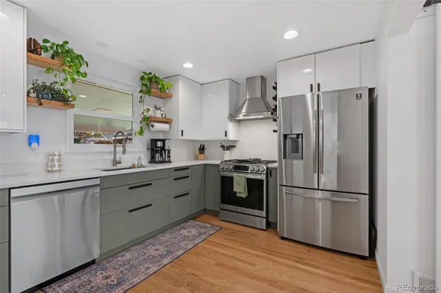 a kitchen with stainless steel appliances a refrigerator sink and microwave