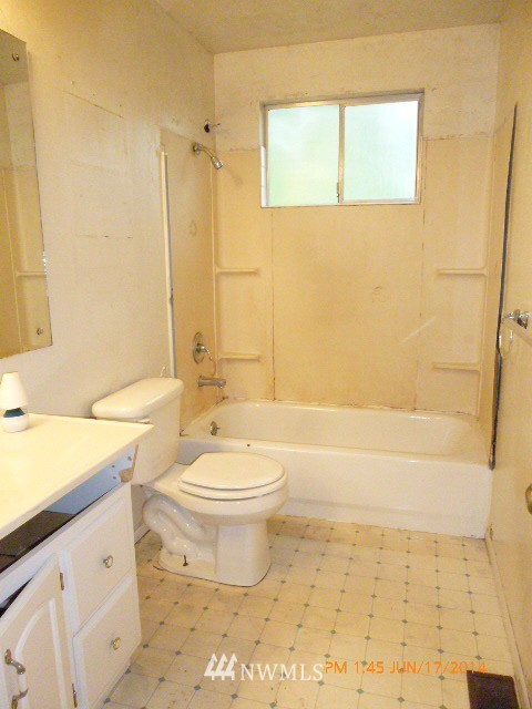 1618 194th Street Southeast Bothell, WA 98012 - Photo 11 of 20 a bathroom with a granite countertop toilet a sink and a bathtub