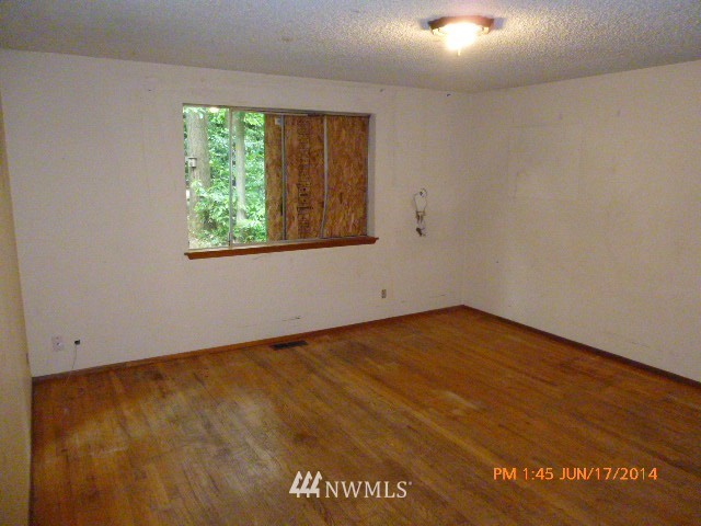 1618 194th Street Southeast Bothell, WA 98012 - Photo 12 of 20 an empty room with wooden floor and windows