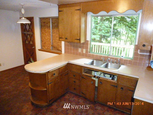 1618 194th Street Southeast Bothell, WA 98012 - Photo 7 of 20 a kitchen with stainless steel appliances granite countertop a sink a stove and a wooden floors