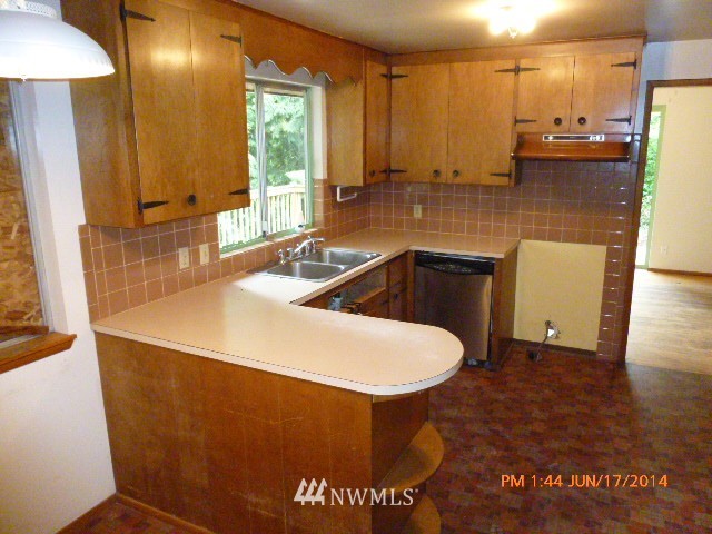 1618 194th Street Southeast Bothell, WA 98012 - Photo 8 of 20 a kitchen with a sink a refrigerator and window