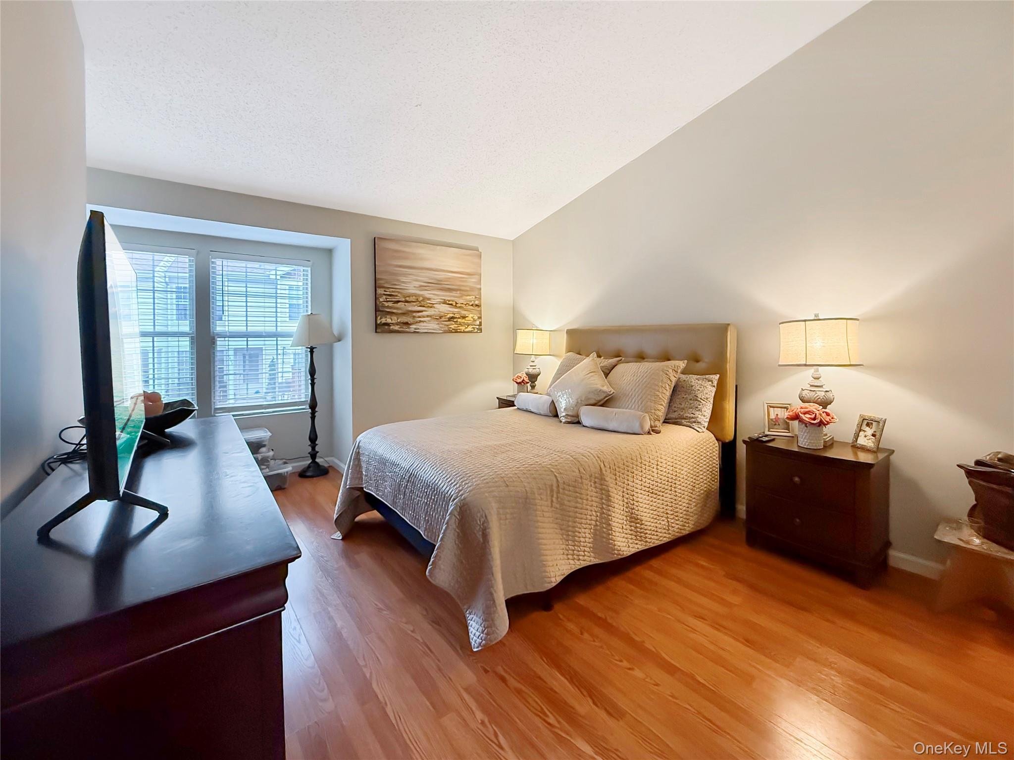 4508 Whispering Hills Road Chester, NY 10918 - Photo 13 of 20 a bedroom with a bed and wooden floor