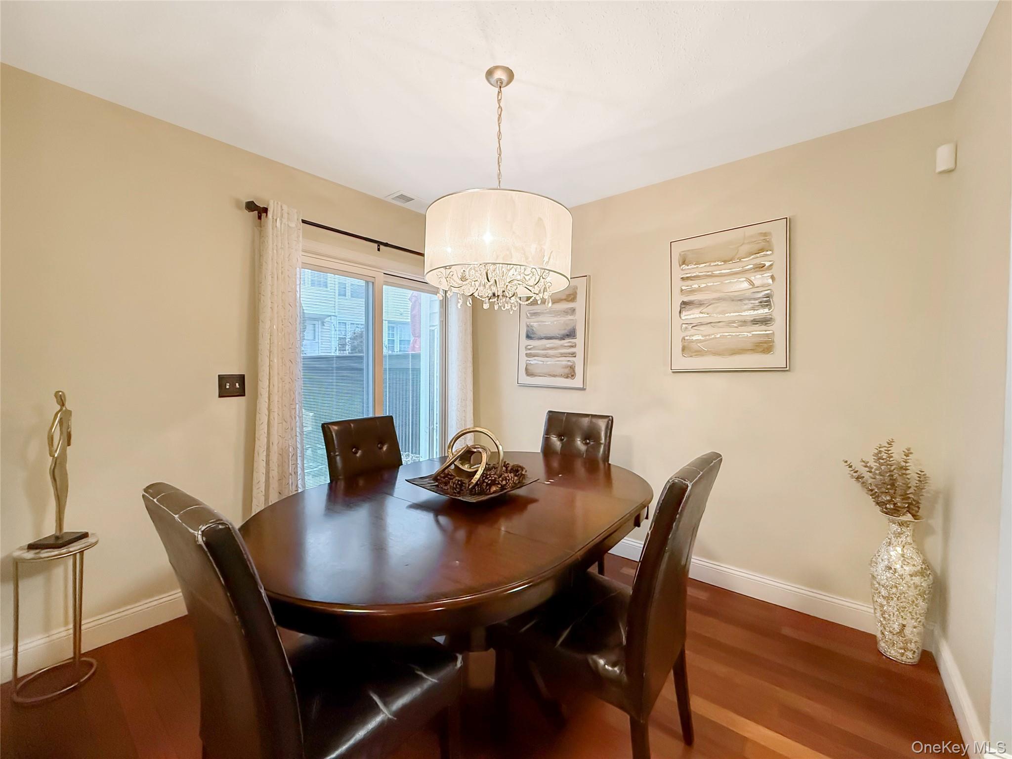 4508 Whispering Hills Road Chester, NY 10918 - Photo 7 of 20 a view of a dining room with furniture window and wooden floor