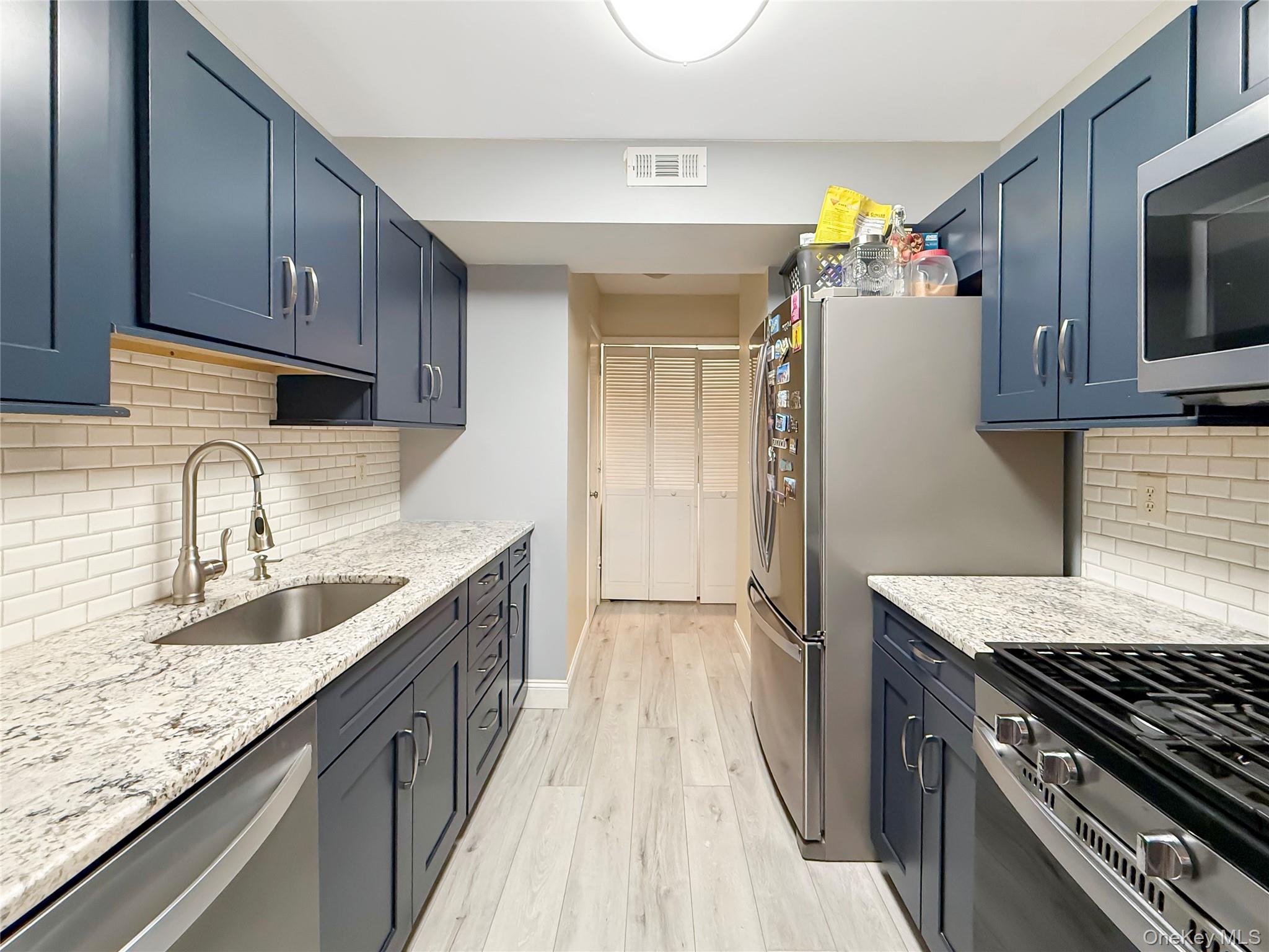 4508 Whispering Hills Road Chester, NY 10918 - Photo 9 of 20 a kitchen with granite countertop a sink stainless steel appliances and cabinets