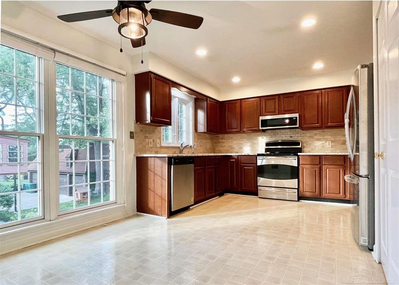 744 Trombley Road Grosse Pointe, MI 48230 - Photo 10 of 32 The updated kitchen has new granite countertops, new marble backsplash and a new designer ceiling fan over the eat-in dining area.
