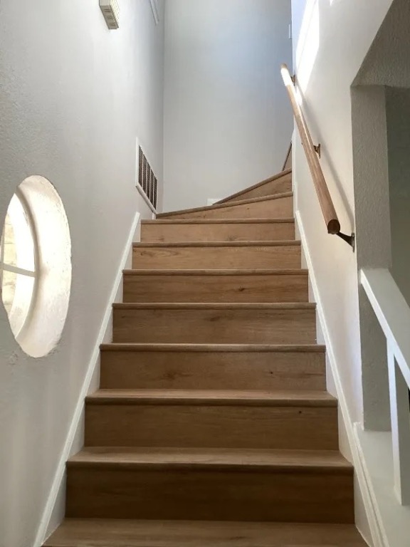 12136 Thompkins Drive, Unit B Austin, TX 78753 - Photo 6 of 7 Stairway featuring wood finished floors