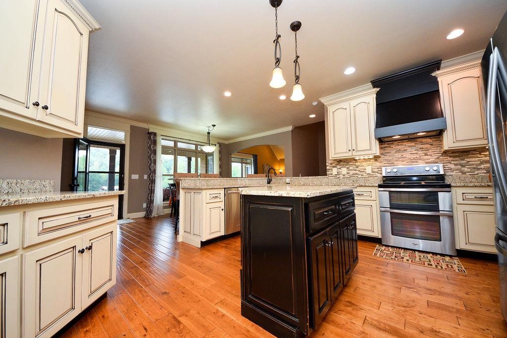 1460 No Pone Road Georgetown, TN 37336 - Photo 8 of 33 a kitchen with stainless steel appliances kitchen island granite countertop a stove a sink and a refrigerator