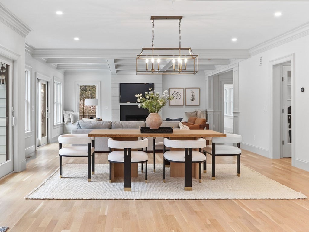 31 Karen Road Newton, MA 02468 - Photo 12 of 41 a living room with chairs a chandelier and kitchen view