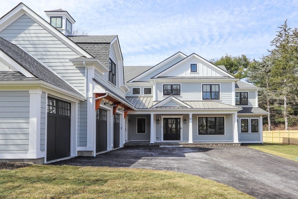 31 Karen Road Newton, MA 02468 - Photo 2 of 41 a front view of a house with a yard and garage