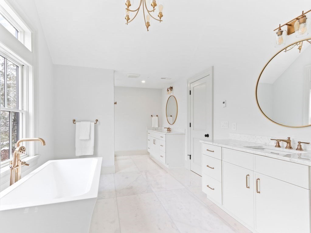31 Karen Road Newton, MA 02468 - Photo 24 of 41 a large white bathroom with a double vanity sink mirror and a bathtub