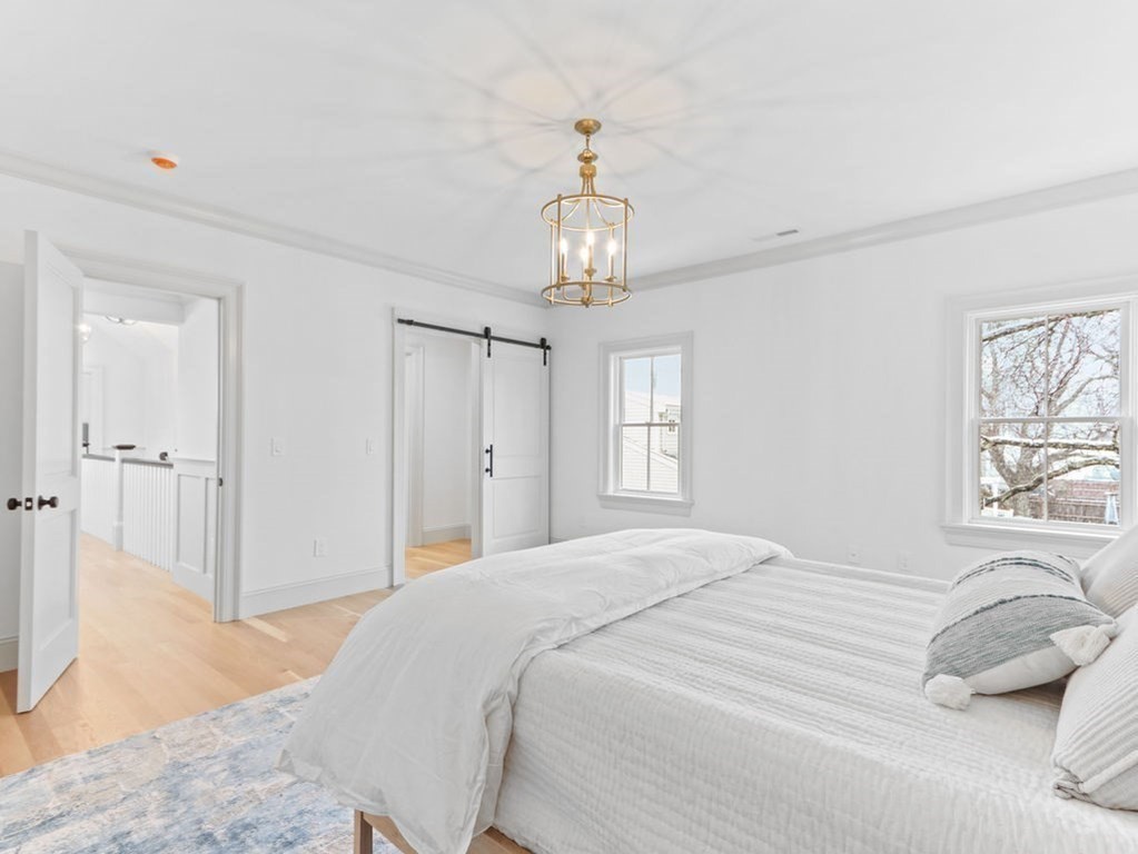 31 Karen Road Newton, MA 02468 - Photo 26 of 41 a bedroom with a bed and a chandelier