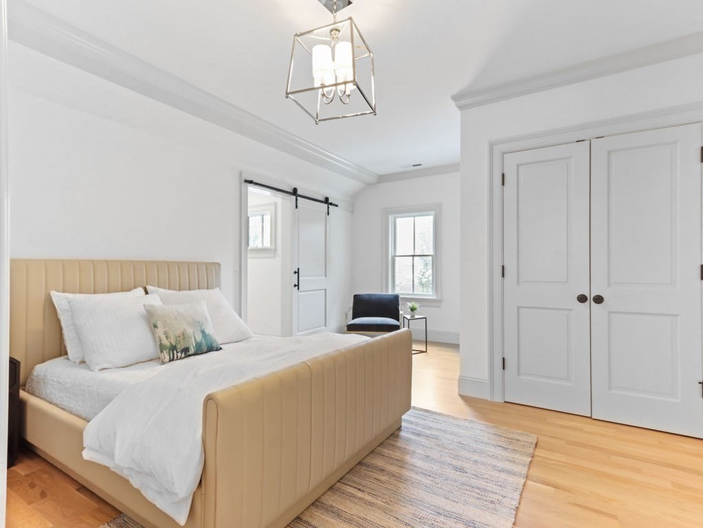 31 Karen Road Newton, MA 02468 - Photo 28 of 41 a bedroom with a bed and wooden floor