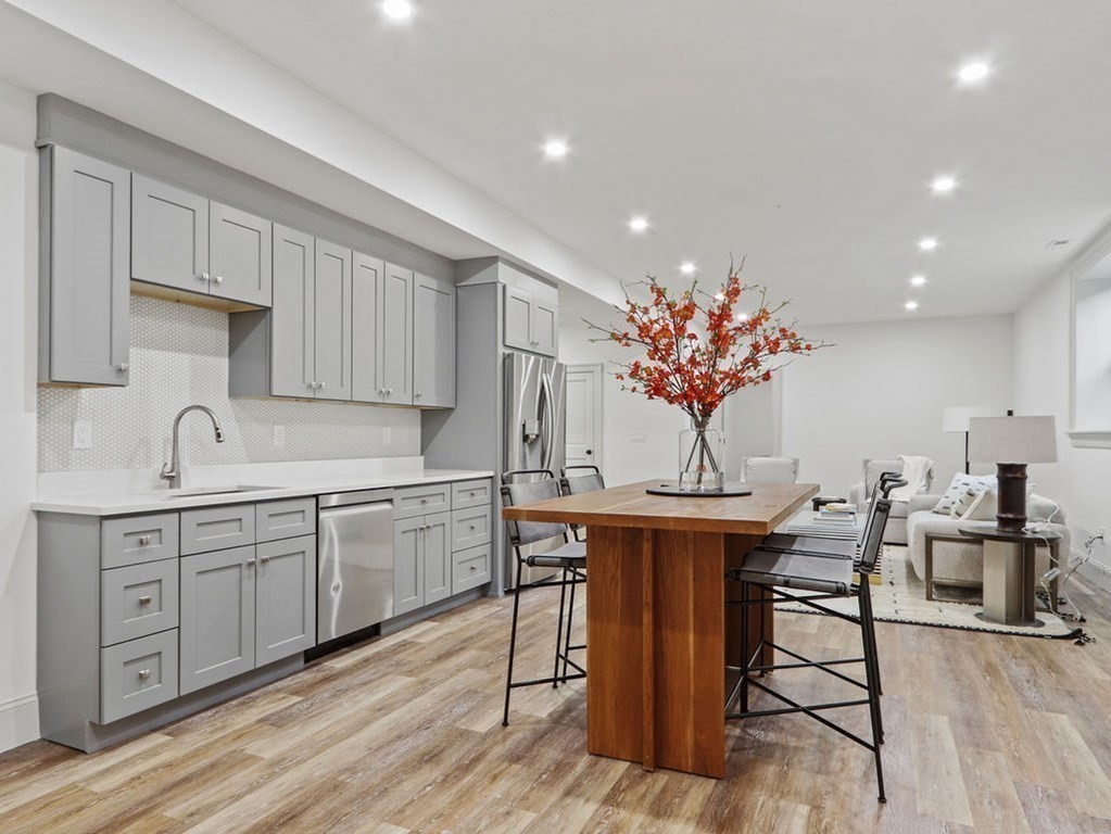 31 Karen Road Newton, MA 02468 - Photo 33 of 41 a kitchen with stainless steel appliances granite countertop a white cabinets and chairs