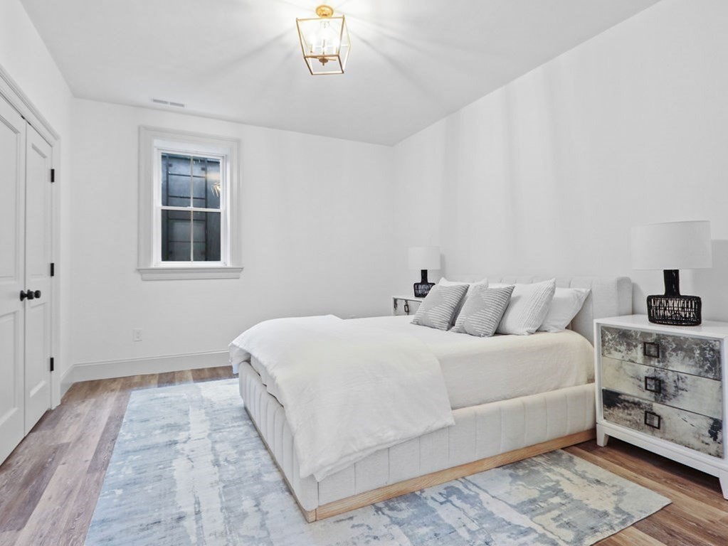 31 Karen Road Newton, MA 02468 - Photo 37 of 41 a bedroom with a large bed and a lamp on dresser