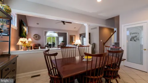 a view of a dining room and livingroom with furniture window and wooden floor