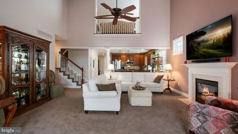a living room with fireplace furniture and a flat screen tv