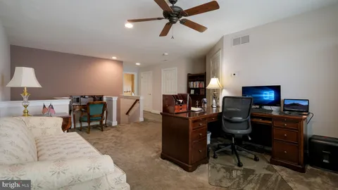 a living room with furniture and a piano