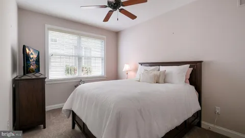a bedroom with a bed and a television