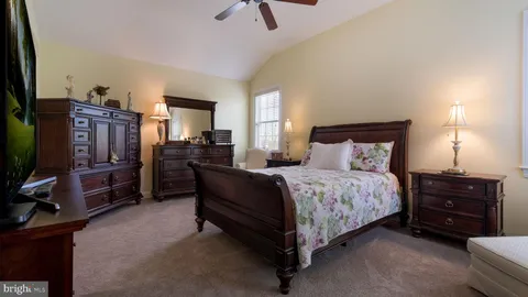 a bedroom with a bed and flat screen tv