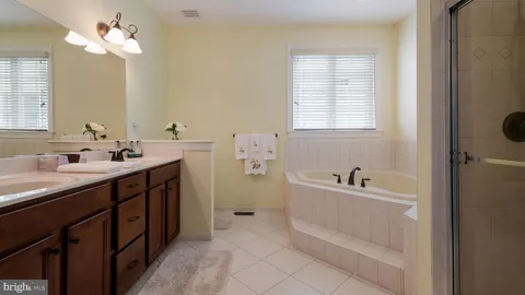 a bathroom with a sink vanity mirror and toilet