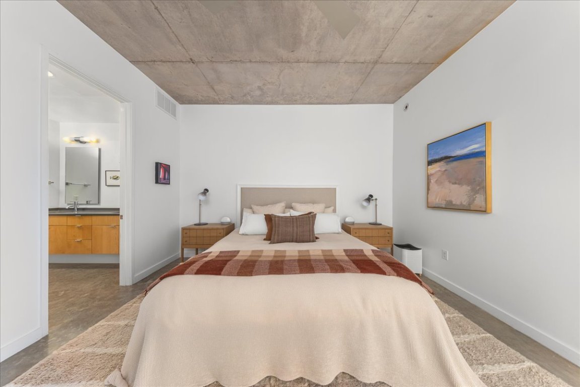 2301 South 5th Street, Unit 6 Austin, TX 78704 - Photo 25 of 40 a bedroom with a large bed and a chandelier