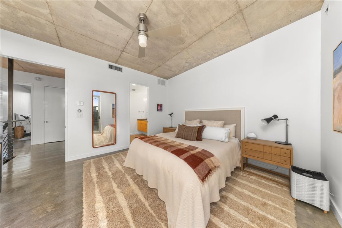 2301 South 5th Street, Unit 6 Austin, TX 78704 - Photo 26 of 40 a spacious bedroom with a bed and a chandelier