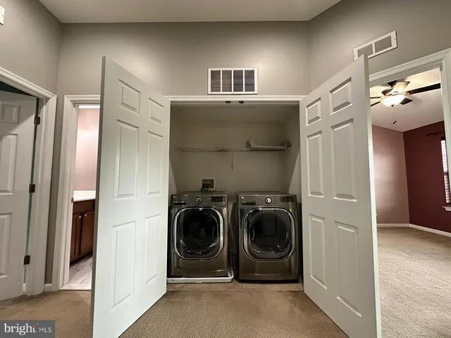 a utility room with closet dryer and washer