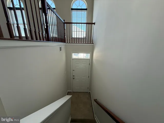 a kitchen with stainless steel appliances granite countertop a stove a refrigerator a sink and a microwave oven with wooden floor