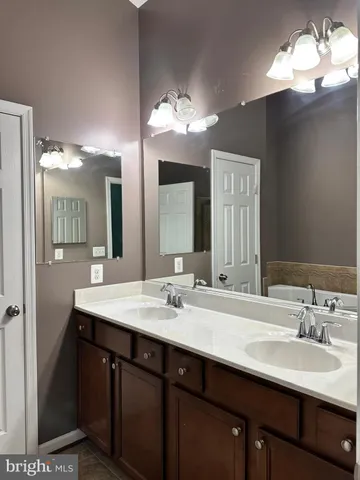 a bathroom with a sink double vanity and a mirror