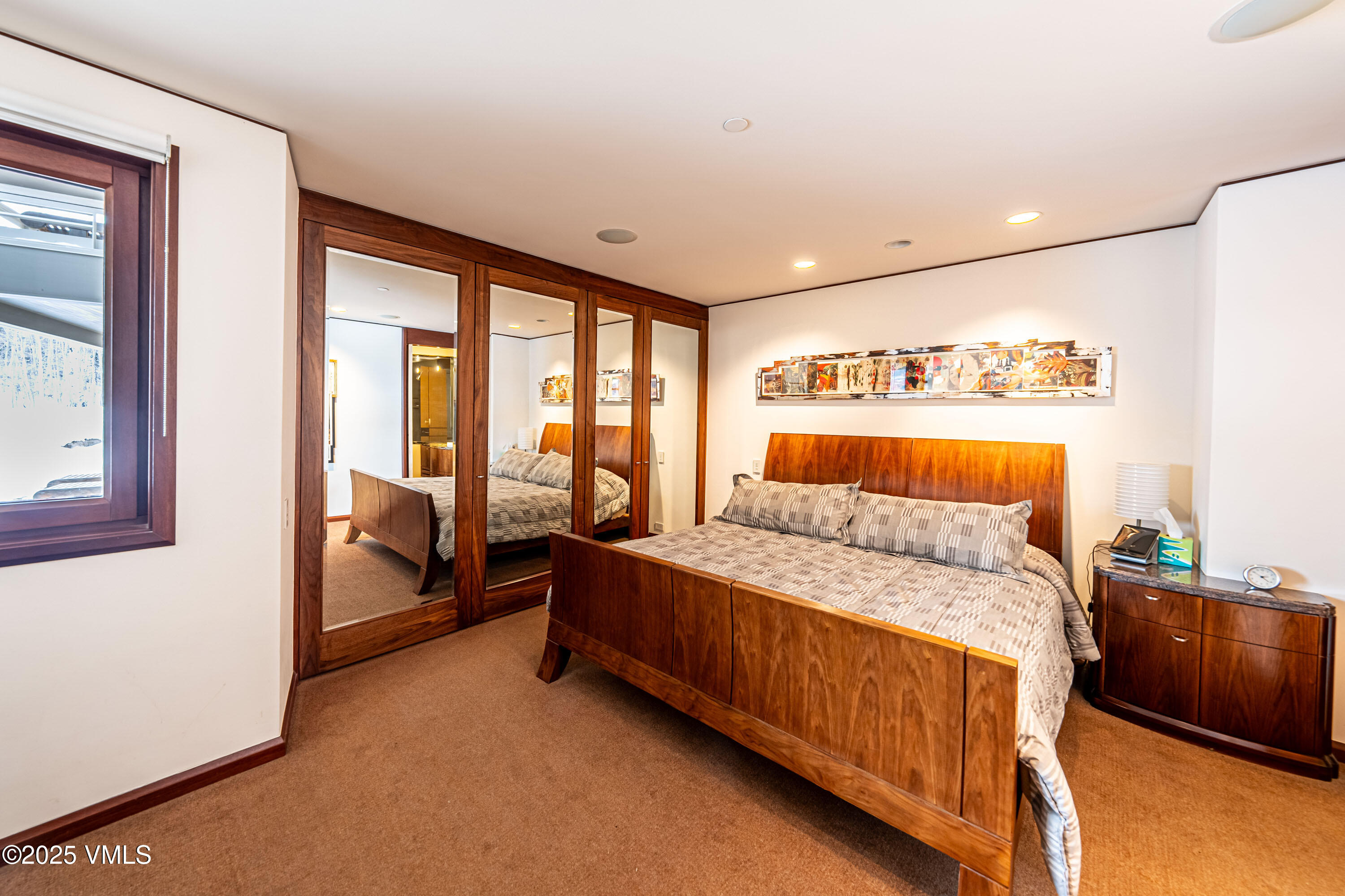 56 Rose Crown Avon, CO 81620 - Photo 27 of 39 a bedroom with a bed and wooden floor