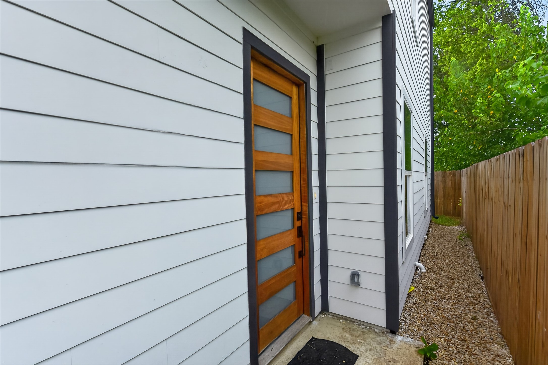3537 Amos Street Houston, TX 77021 - Photo 11 of 32 A concrete walkway leads to the contemporary front door, opening into bright, connected living spaces that flow naturally through to the backyard.